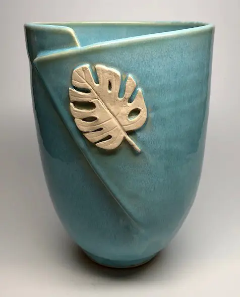 A vase with a leaf design