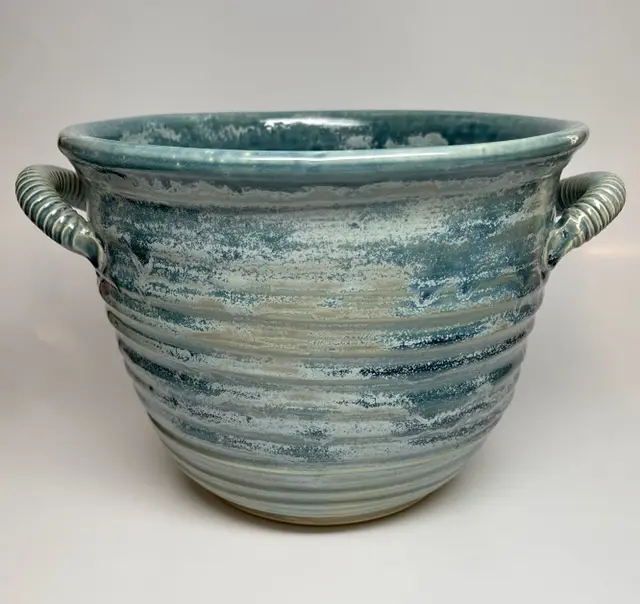 A blue pot with handles