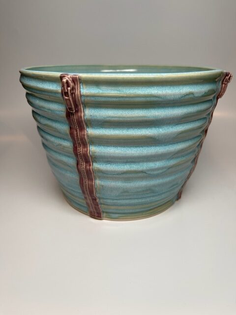 A blue bowl with zipper design
